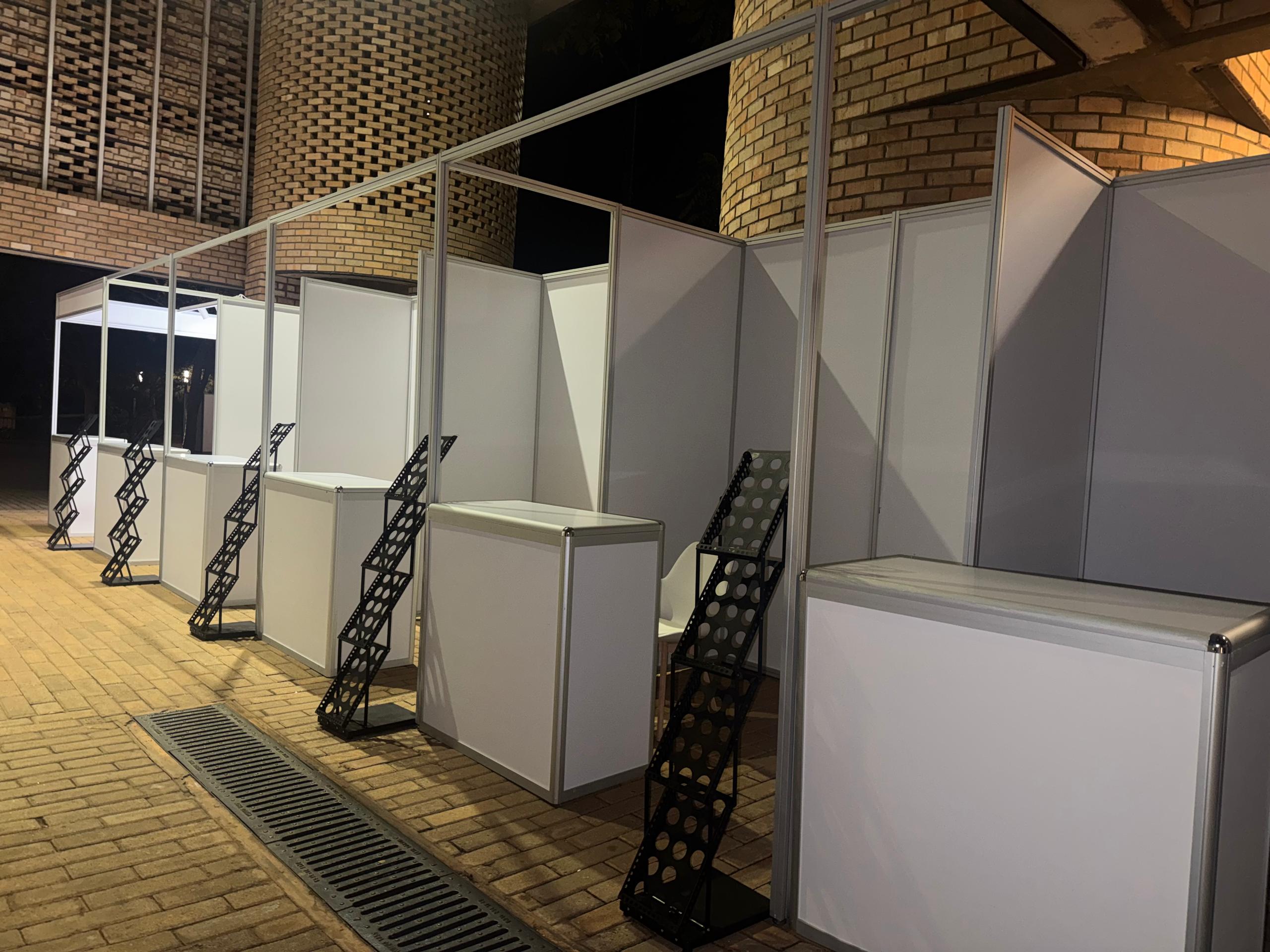 Shell scheme booths with counters and brochure racks built at night