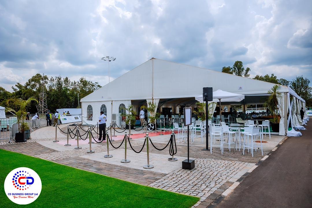 Large marquee tent with stanchions and red carpet entrance