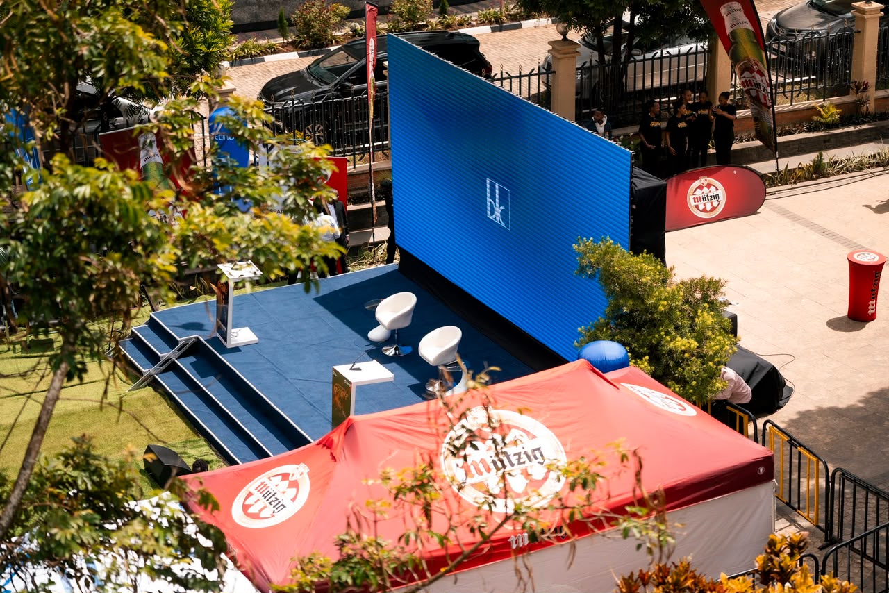 Outdoor brand activation stage with LED screen and branded tents